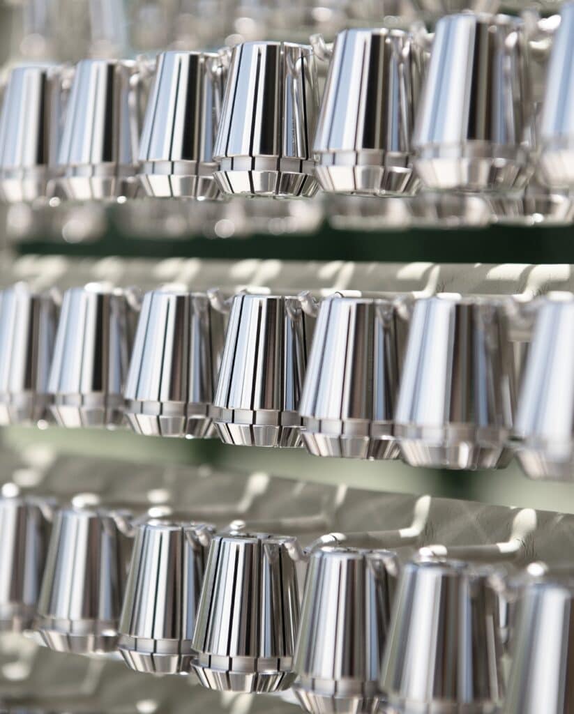 Multiple rows of shiny collets, carefully displayed on a rack.