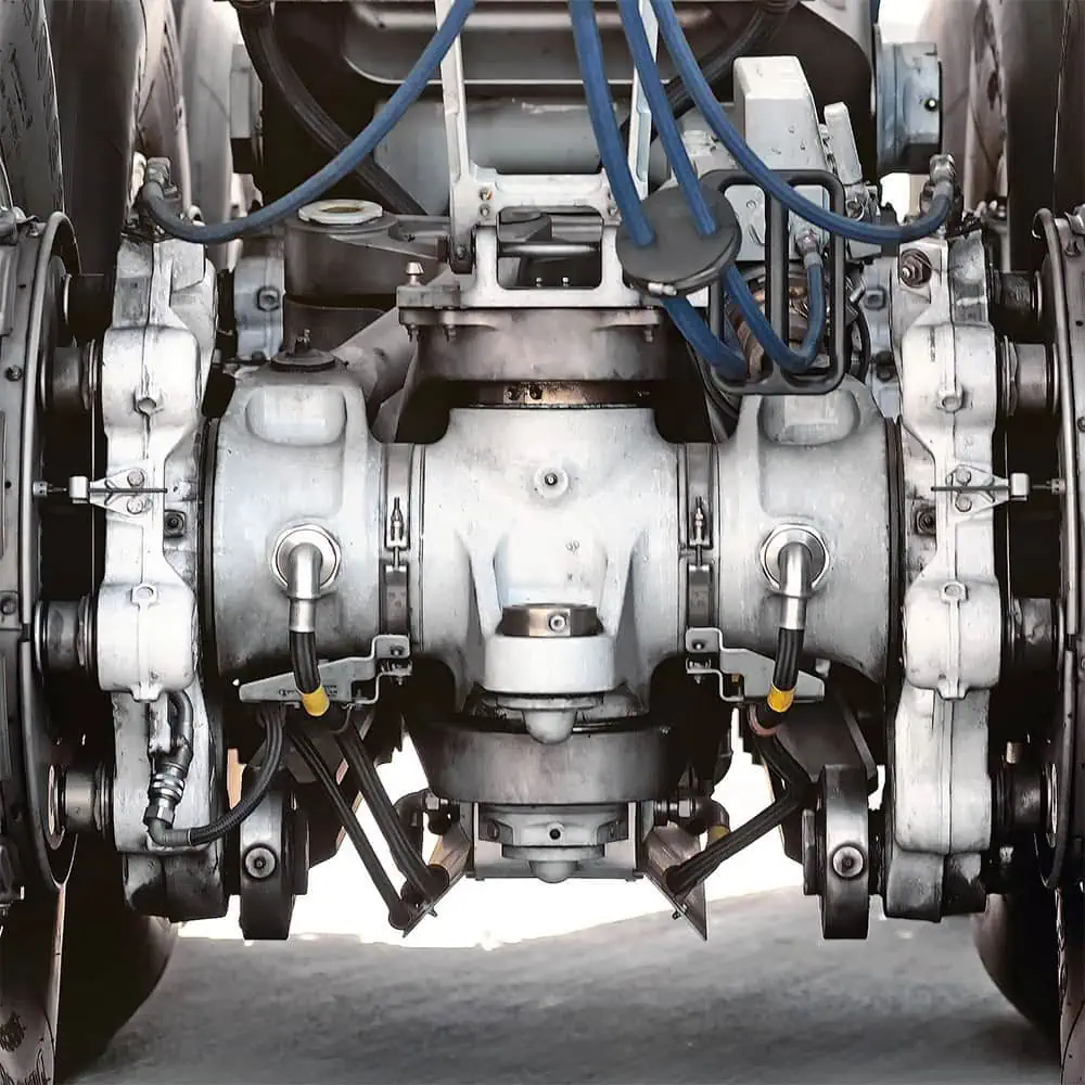 Detailed view of the landing gear of a passenger airplane with visible cables and hydraulic components.