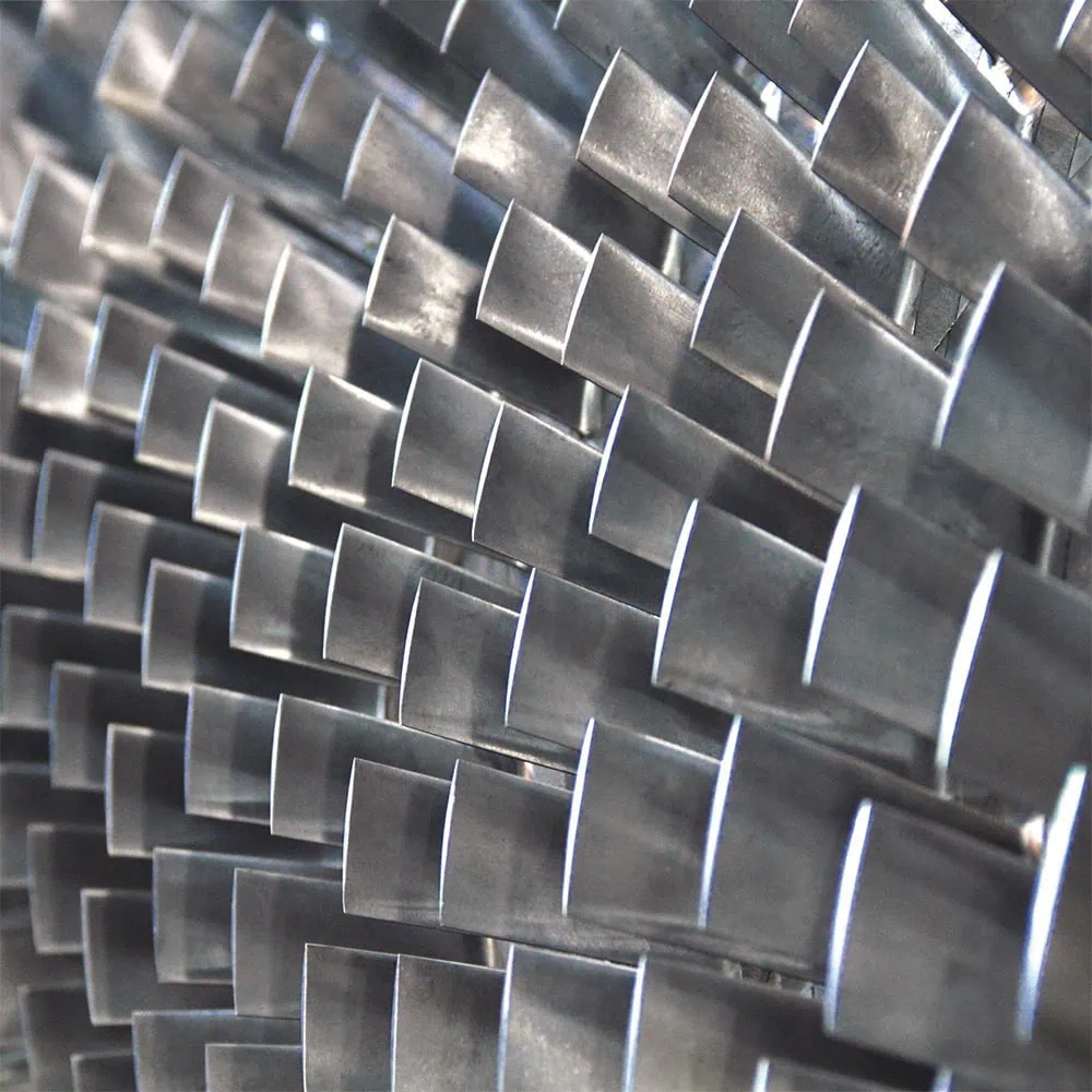 Close-up of metallic turbine blades in a regular arrangement.